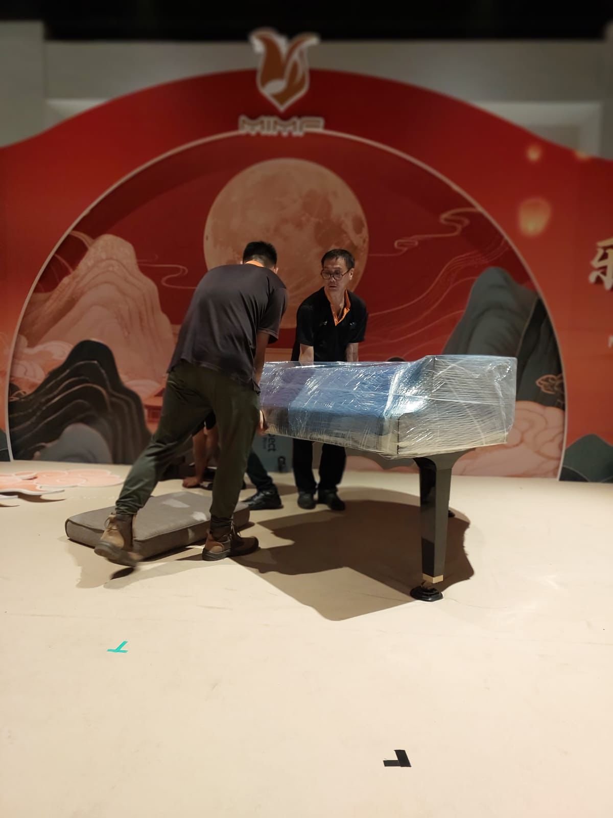 Aspect specialist crew moving an upright piano in Singapore