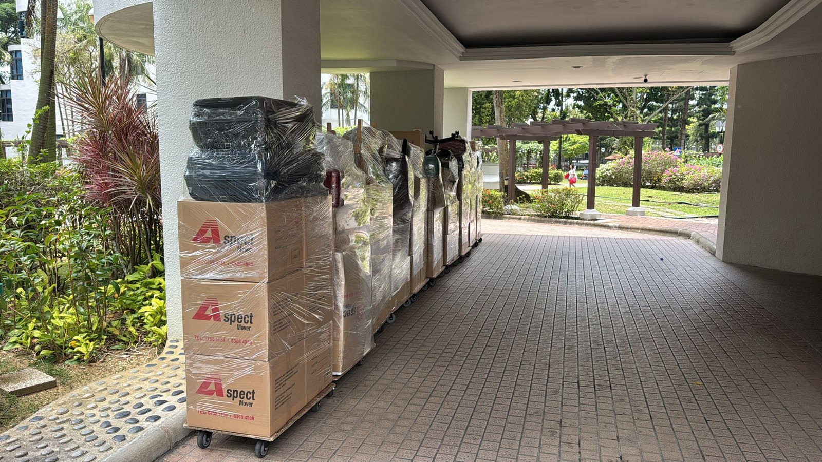 Aspect Mover cartons and wrapped goods staged on trolleys before loading